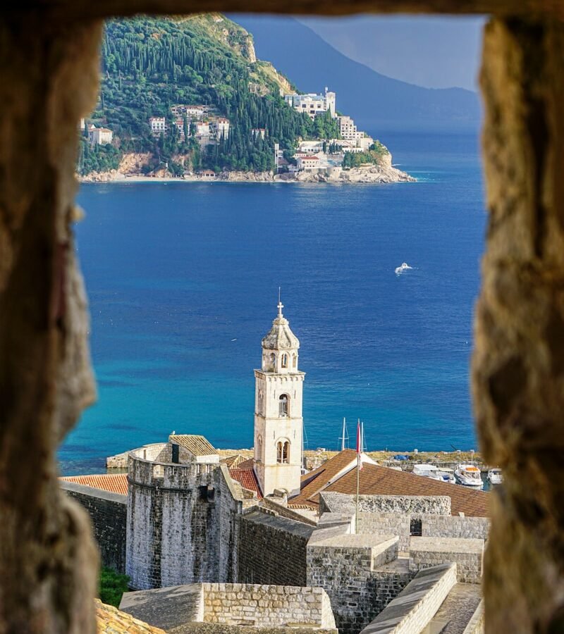 brown concrete building near body of water during daytime