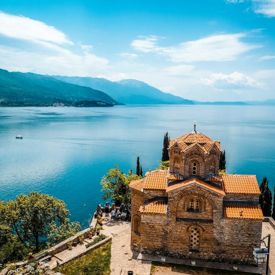 a church on a hill overlooking a body of water